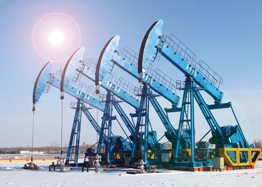 Row of blue oil pump jacks in a field